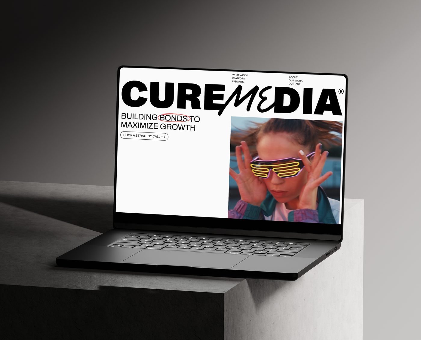 Cure Media website on a laptop